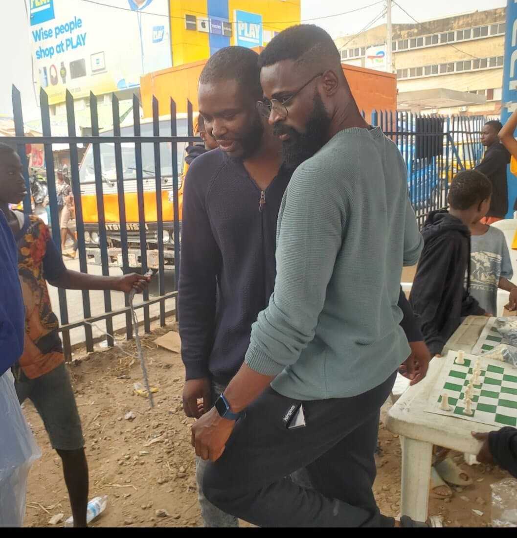 Emmanuel and Tunde Onakoya at a Chess in Slums Africa event, Mokola underbridge, Ibadan, Emmanuel Anaiye Ifebunmi art