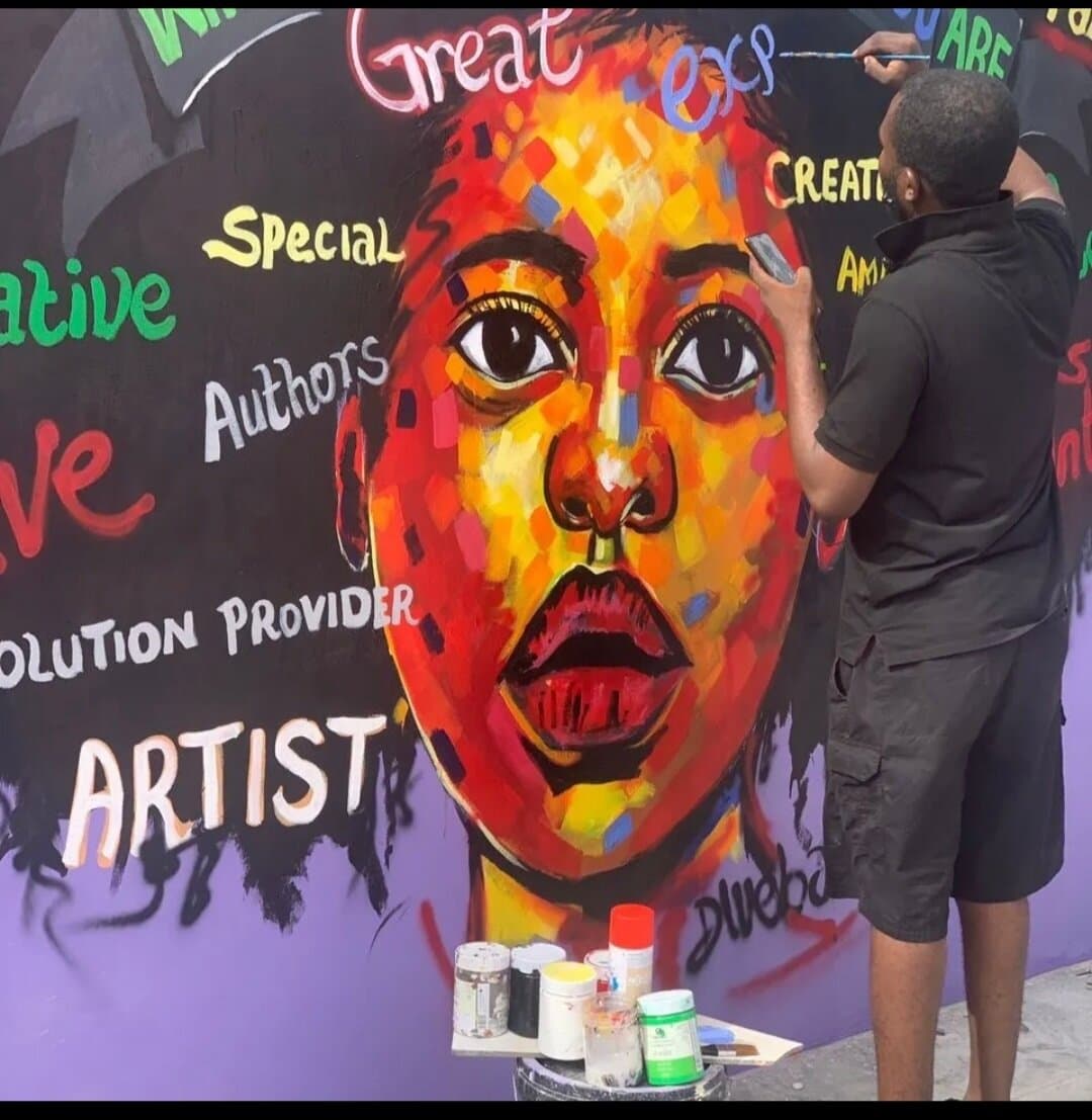 Painting the Dream Catchers Academy mural on site, Emmanuel Anaiye Ifebunmi art